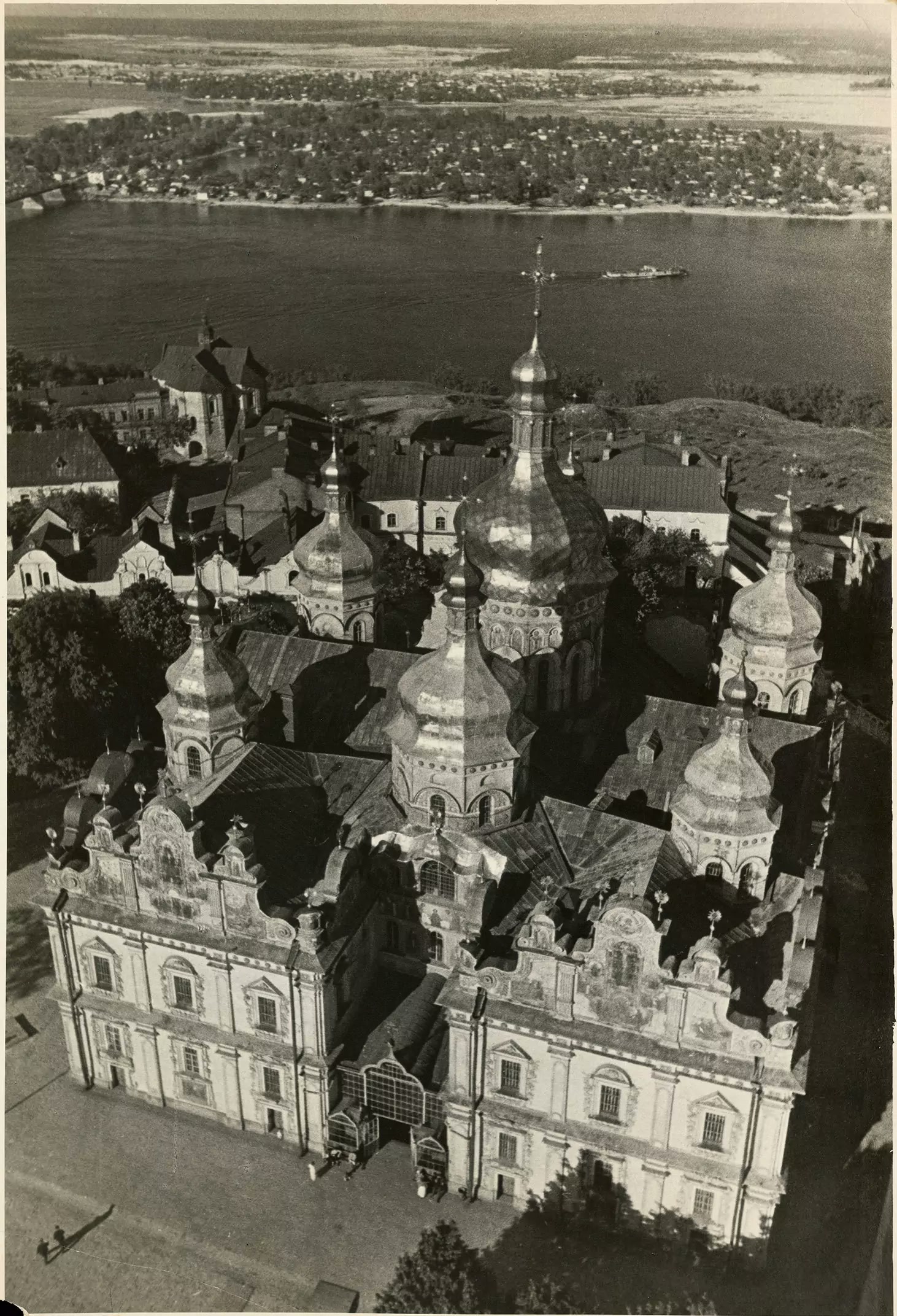 Black-and-white aerial photograph of the Lavra's gold-domed cathedral with the Dnipro river behind, c. 1936.